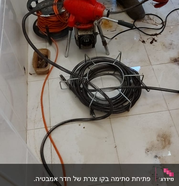אינסטלטור עם מכונת ניקוי צינורות וכלים נוספים